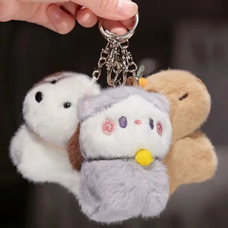 Porte-clé capybara peluche avec une orange sur la tête, à enrouler au poignet