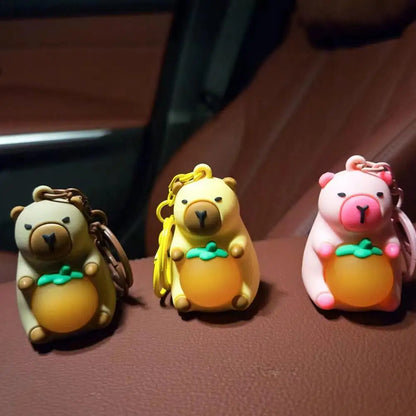 Porte-clé capybara lumineux LED en marron rose ou jaune