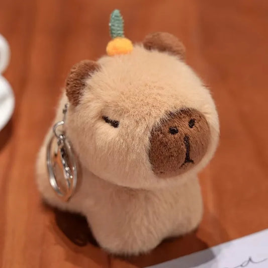 Porte-clé capybara peluche avec une orange sur la tête, à enrouler au poignet